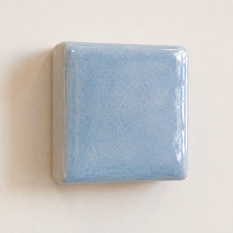 Close-up of baby blue crackle glaze ceramic square by Lagomá