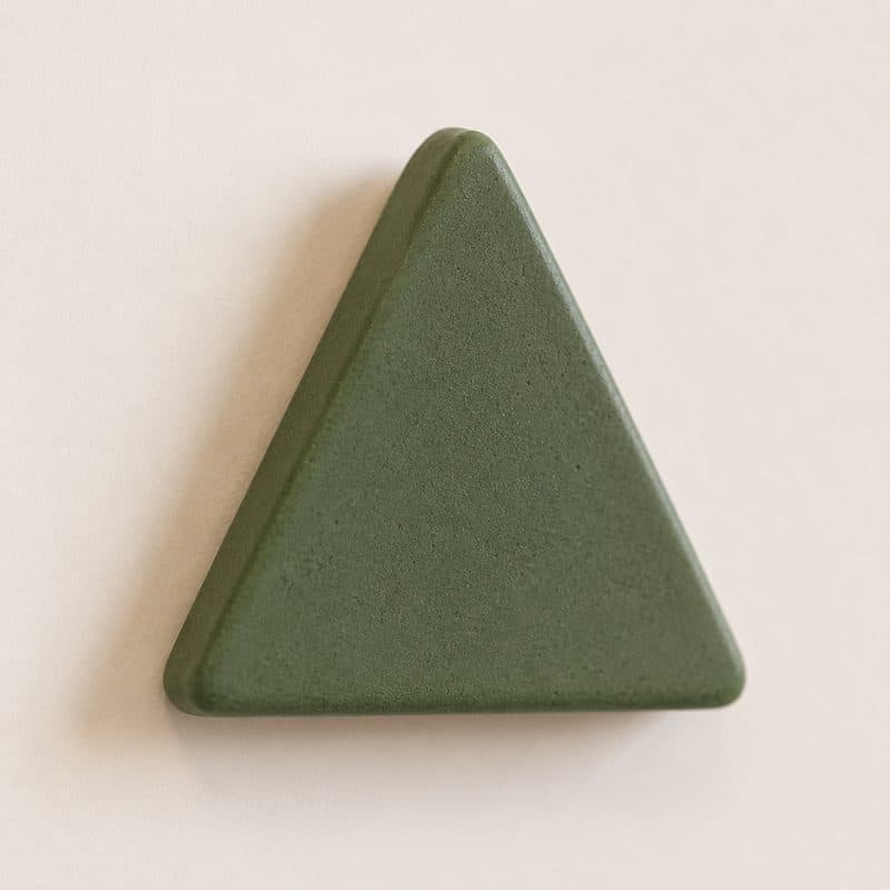 Close-up of forest green matte ceramic triangle by Lagomá